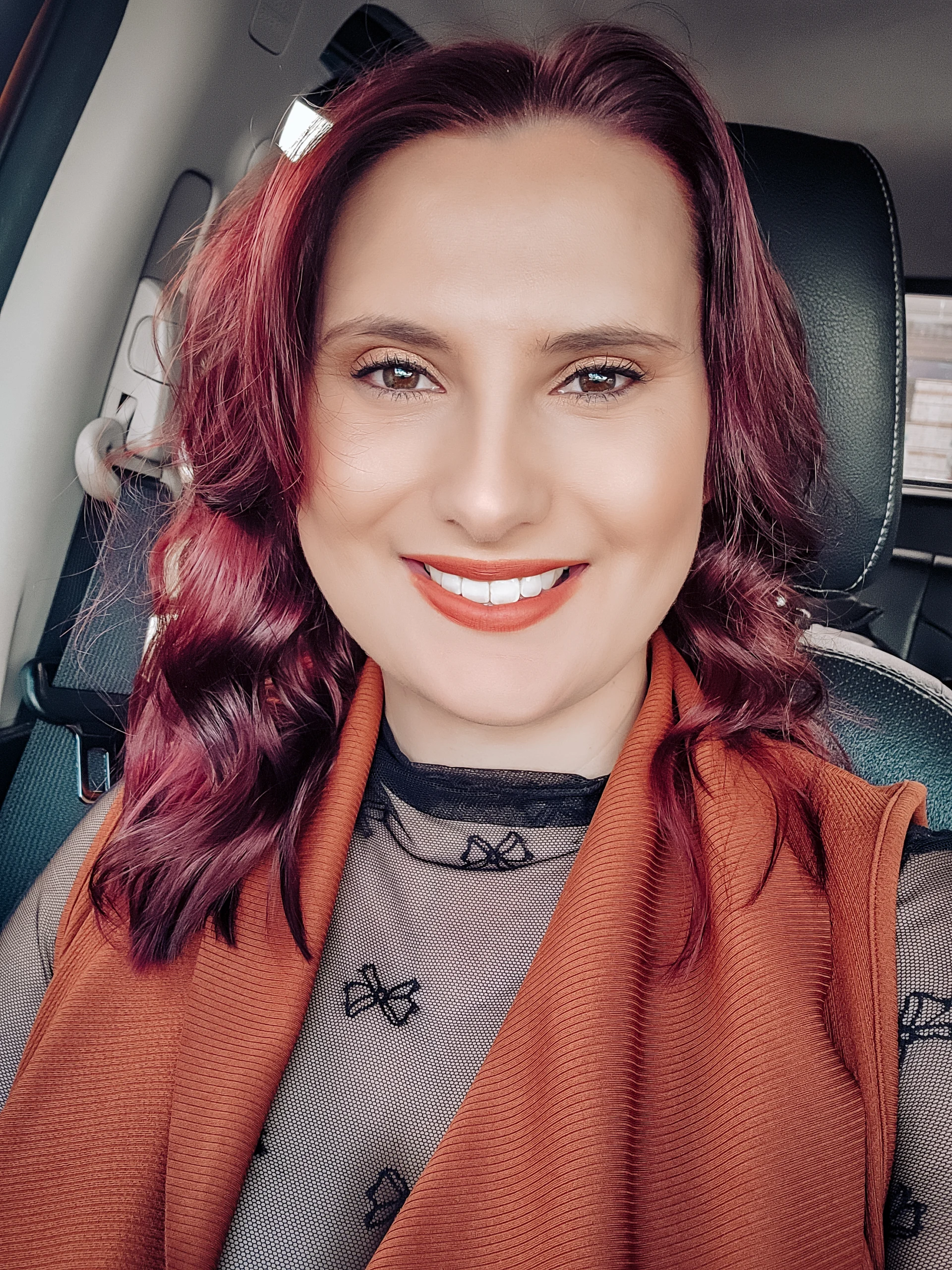Smiling photo of Marinda Troskie, the founder of a lifestyle and fashion blog, with red hair and a stylish top.
