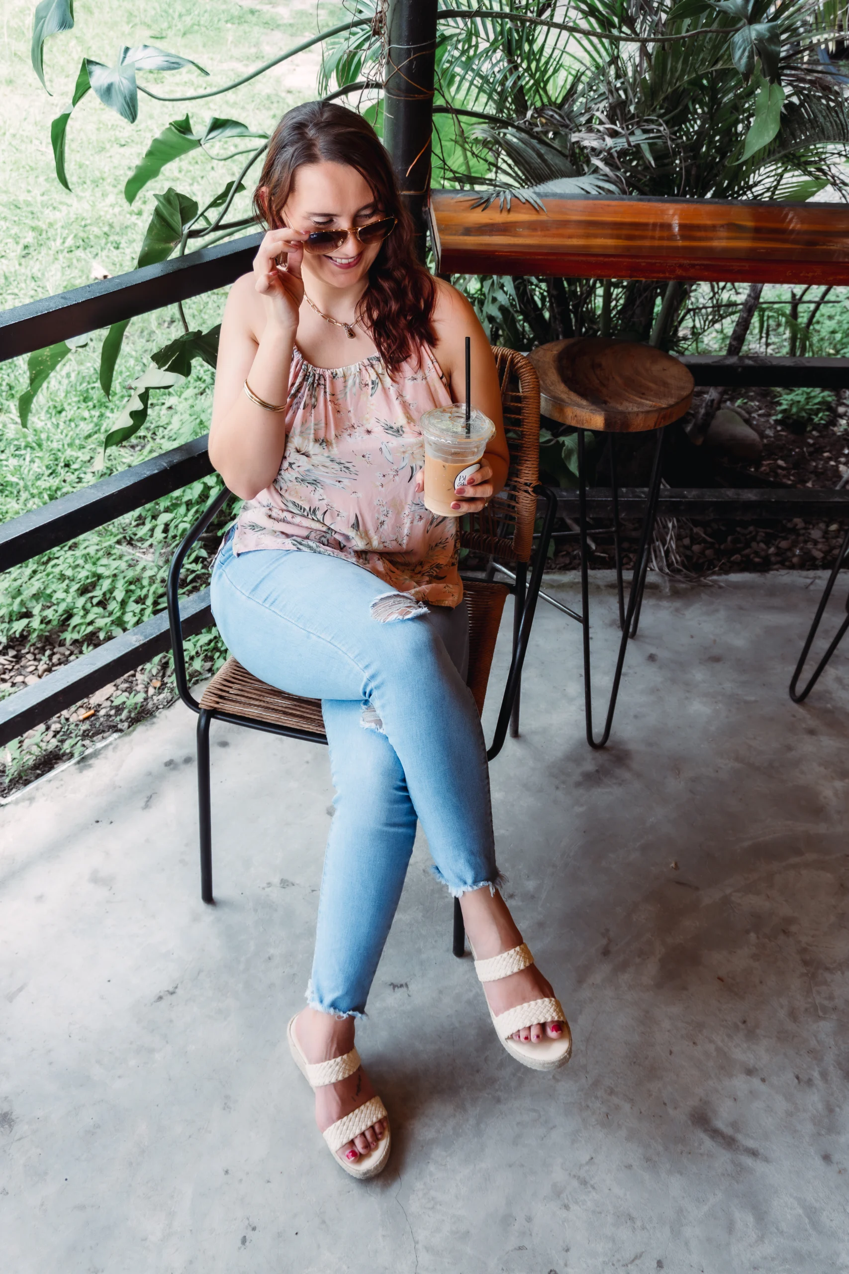 Woman enjoying iced coffee in a casual chic outfit – lifestyle, fashion, and beauty blog cover photo for About Life by Rinda